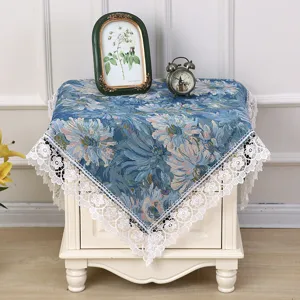 Detailed view of vintage blue floral fabric dust cover with elegant white lace trim.