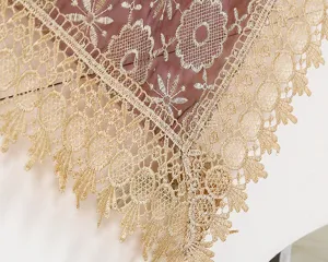 Detailed close-up view of elegant gold lace embroidered tablecloth, exquisite dust cover runner.