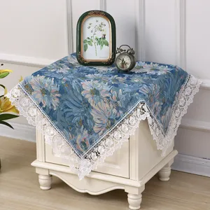 Close-up of vintage French botanical blue floral dust cover fabric with exquisite lace trim.