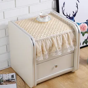 Quilted bedside table cover with delicate lace trim, dustproof protection for nightstands.
