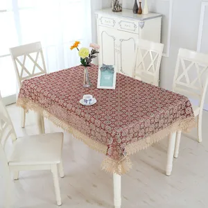 Elegant red floral lace tablecloth with fringe border for dining room table decoration.