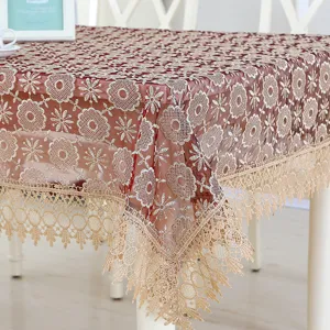 Elegant embroidered lace tablecloth with exquisite tassels, perfect for dining table decor.