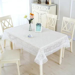 Elegant white lace tablecloth with floral embroidery, perfect for dining table decor.