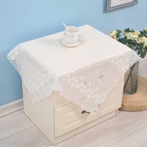 White lace dust cover for bedside table, elegant floral design home decor, durable fabric protector.