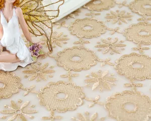 Golden embroidered lace tablecloth detail, floral fabric for home decor and table decor.
