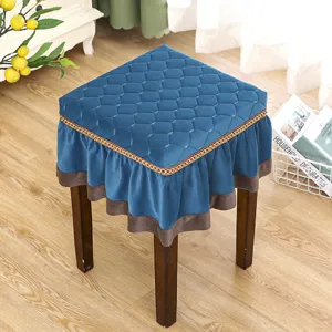 Thick blue velvet square stool cover with ruffles and golden trim for home decor.
