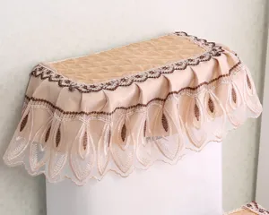 Fabric toilet tank cover detail showing quilted design and elegant lace embroidery.