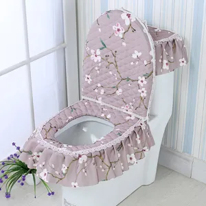 Floral toilet seat cover three-piece set, quilted fabric with lace trim for bathroom decor.
