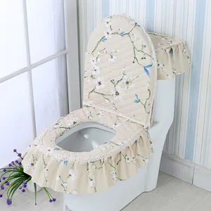 Detailed view of the quilted floral toilet seat cover set with elegant lace trim design.