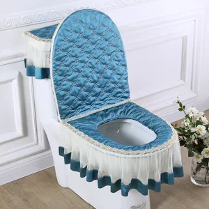 Blue quilted toilet seat cover set with elegant lace mesh skirt and dust cover for bathroom.