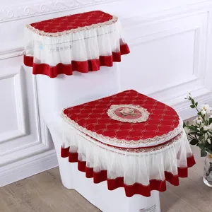 Red and white fabric toilet cover set with lace ruffle and rose embroidery for bathroom decor.