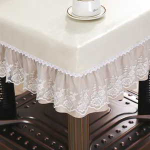 Detail view of PU leather table cover with delicate white lace trim and waterproof texture