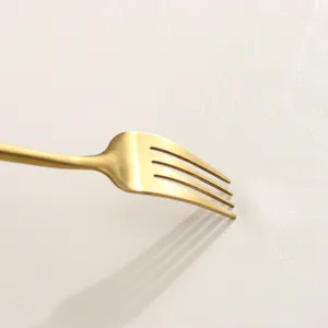 Gold fork detail shot showcasing premium PU leather table mat texture and waterproof finish.