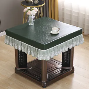 Detailed view of dark green PU table cover with white lace, waterproof electric fire cover.