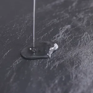 Waterproof PU table mat detail view showing liquid repellent surface and leather texture.