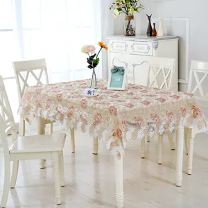 Close-up of European pastoral style embroidered lace tablecloth detail in bright home setting.