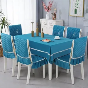 Detailed view of peacock blue quilted tablecloth and chair covers with lace