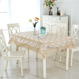 Elegante tovaglia in pizzo ricamato beige con motivi floreali in una sala da pranzo chic