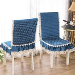 Vue détaillée d'une housse de chaise de salle à manger en velours avec bordure en dentelle.