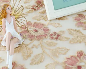 Exquisite embroidered lace tablecloth with floral hollow design for elegant home table decor.