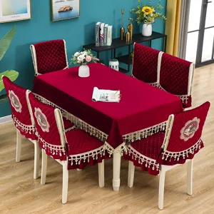Detail shot of Italian velvet dining tablecloth and chair cover set with elegant lace trim.