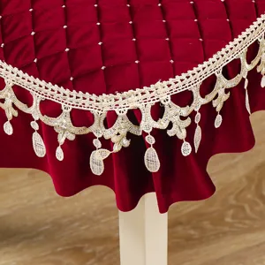 Detailed view of dark red velvet dining chair cover featuring elegant gold lace trim.