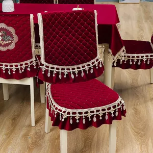 Red velvet dining chair cover and matching tablecloth set with elegant lace tassel trim.