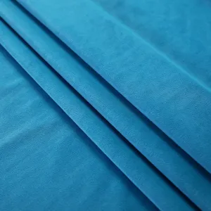 Blue velvet fabric detail close up showing soft texture and elegant folds for home decor.