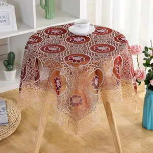 Detail view of brown lace embroidered hollow tablecloth, elegant floral mesh cover for table decor.