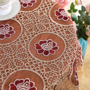 Lace embroidered hollow tablecloth detail view, featuring intricate red floral mesh design.