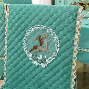 Quilted teal chair cover detail, soft flannel fabric, elegant lace trim and deer embroidery.