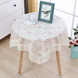 Elegant round lace tablecloth with delicate floral embroidery, perfect for home tea table decor.