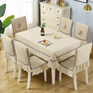Detailed view of quilted dining chair cover and tablecloth set with cute deer embroidery.