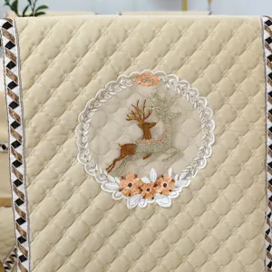 Quilted velvet dining chair cover with exquisite deer embroidery and elegant lace trim detail.
