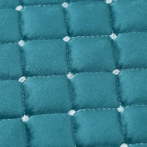 Italian velvet dining chair pad detail, soft plush fabric with quilted square stitch design.