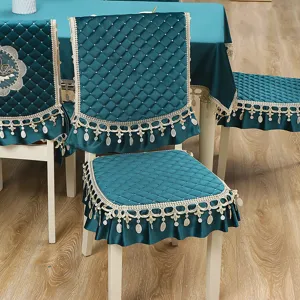 Teal velvet dining chair cover and tablecloth set with quilted pattern and elegant lace fringe.