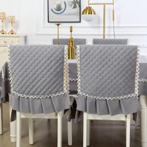 Grey quilted dining chair cover with lace trim, one-piece flannel seat and backrest protector.