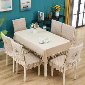 Elegant beige velvet dining tablecloth and chair covers set with quilted design and tassel trim.