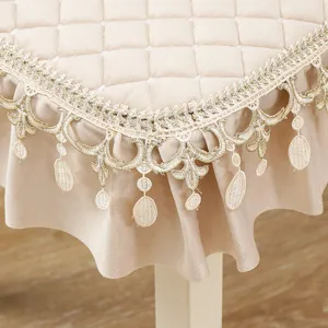 Detailed view of luxury velvet dining chair cushion with exquisite gold lace trim and quilting.