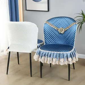 Detail view of the elegant quilted dining chair cover featuring delicate lace and floral decor.