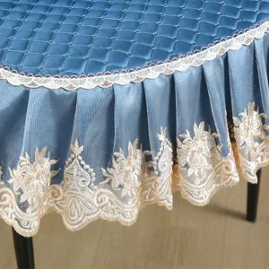 Blue quilted dining chair cover detail, elegant lace embroidery trim, soft and durable fabric.