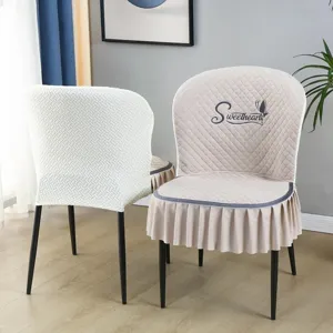 Detailed view of quilted dining chair cover with elegant skirt and backrest embroidery design