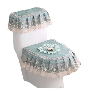Green fabric toilet seat cover set with elegant lace ruffle and sweet heart motif for bathroom.