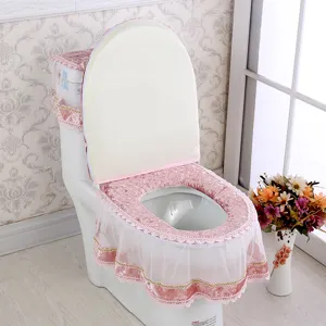Pink velvet toilet seat cover set with delicate white lace trim for bathroom decor detail