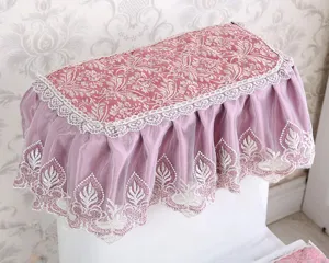 Detailed view of the pink velvet toilet lid cover featuring delicate lace embroidery trim.
