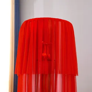 Red mesh vertical air conditioner dust cover, elegant ruffled lace design for home decor.