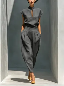 Detailed view of the dark grey linen two-piece set, featuring mock neck and pleated barrel pants.