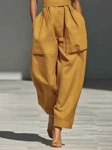 Linen blend loose women jumpsuit detail shot showcasing high waist and pleated wide legs.