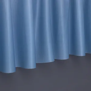 Light blue dust cover fabric with natural vertical pleats and elegant draping texture.