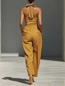 Back view detail of the women linen blend halter neck casual loose jumpsuit in yellow.